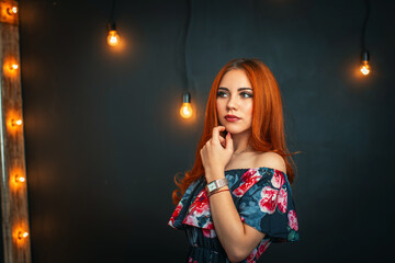 Naklejka premium attractive young girl with evening makeup and an open dress looks away.