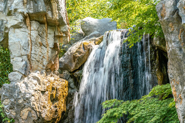 Fototapeta na wymiar Waterfall- water cascading down some rocks