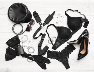 Set of female accessories on light wooden background