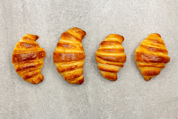 Row of croissant on a gray background