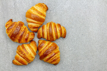 Pattern from croissants on a gray background