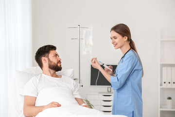 Female doctor working with patient in hospital room