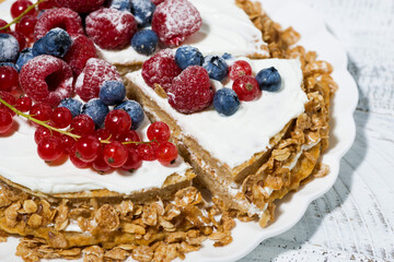 healthy sweet oatmeal cake with yoghurt and fresh berries on white background, closeup