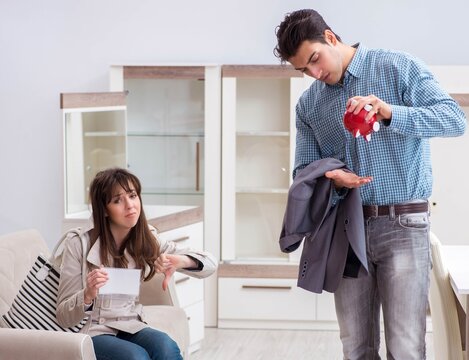 Young Couple Saving Money For New Furniture