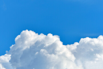Obraz na płótnie Canvas Fluffy more clouds in the blue sky with copy space.
