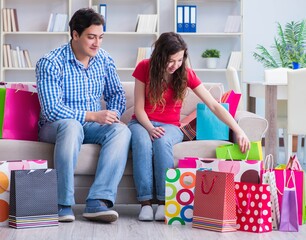 Young pair after shopping with many bags
