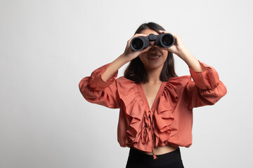 Young Asian woman with binoculars .