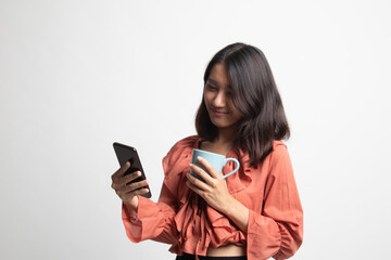 Fototapeta premium Young Asian woman with mobile phone and coffee cup .