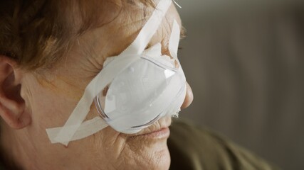 Portrait of an elderly woman with the eye patch after the cataract surgery. Close up.