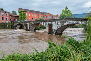 Climate change: flooding river hits the bridge after a storm in Luino