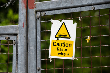 Caution Razor Wire sign on a wire fence