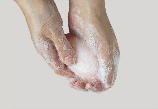 Woman washes hands with soap