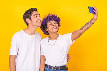 isolated young couple smiling for photo with mobile phone