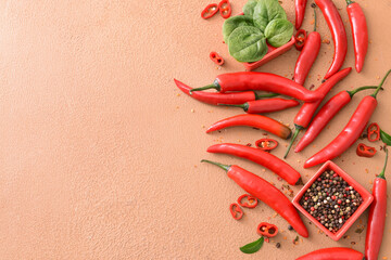 Composition with hot chili pepper on color background