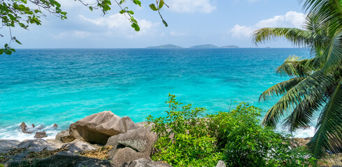 Beautiful seascape with palm tree on tropical beach, La Digue, Seychelles. Summer vacation and travel concept. panoramic seascape
