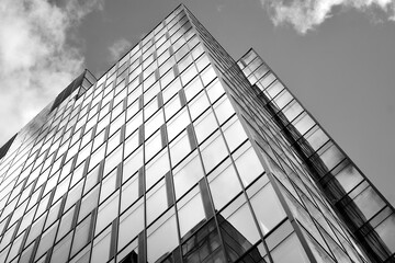 Urban geometry, looking up to glass building. Modern architecture, glass and steel. Abstract modern architecture design with high contrast black and white tone.
