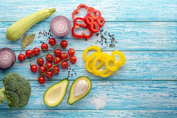 Various vegetables  on blue wood background. Top view with copy space. Vegetarian and vegan food