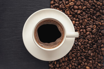 cup of coffee on a black stone surface top view