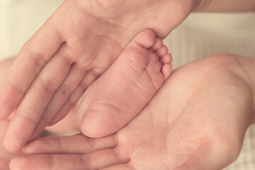 foot of a newborn baby in mom’s hands