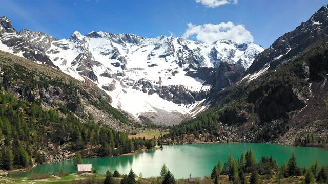 Flying Low over D'Aviolo Lake, Italy.
Aerial View of Colourful Turquoise Water. Mountains View. Blue Sky.