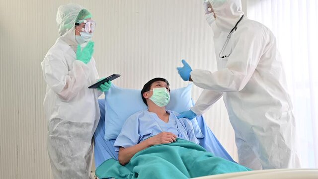 4K Doctors in PPE suit checking infected patient during coronavirus outbreak