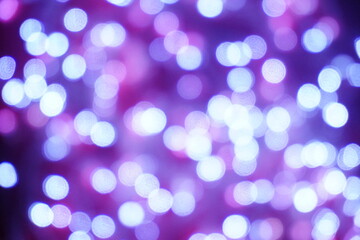 Blue lights on a purple background are blurred. Concept of blank frame,copy space. Christmas or new year flatlay background.