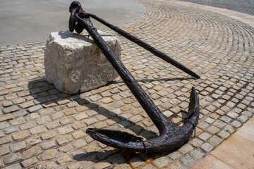 Nautical symbol. Big rusty old anchor out of the water. © canduca