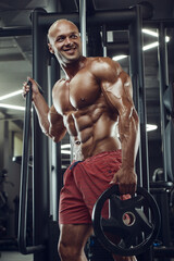 Fototapeta na wymiar Bodybuilder athletic man workout muscles exercise
