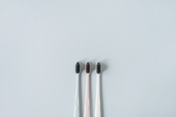 Toothbrushes on blue background. Flat lay, top view minimal oral care, dental hygiene concept