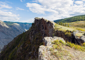 Fototapeta na wymiar A steep cliff in the Altai mountains, the Bank of the Chulyshman river, the katu-Yaryk pass