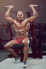 Obraz na płótnie Canvas Bodybuilder athletic man workout muscles exercise