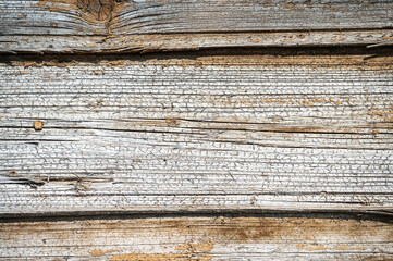 old cracked texture wooden wall of a barn. peeling paint on an old building. natural materials for construction
