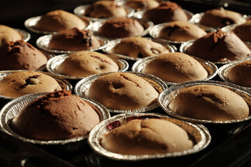 Warm cupcakes with chocolate and berries fresh from the oven