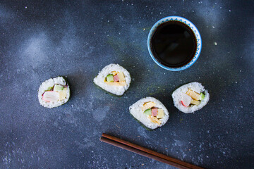 Kimbab or kimbap on the blue background with soy souse, blue background, studio shoot.