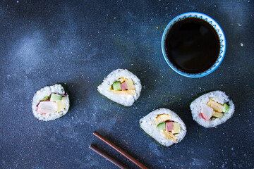 Kimbab or kimbap on the blue background with soy souse, blue background, studio shoot.