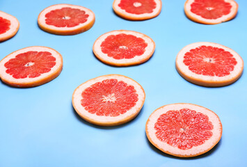 Fresh sliced grapefruit on color background