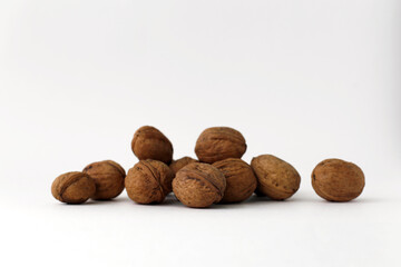 Walnuts lie on a white background. Healthy food close-up.
