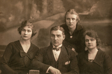 Latvia - CIRCA 1920s: Group portrait shot of three female and man in studio. Vintage Carte de Viste Art Deco era photo