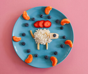 Lamb on a plate
Cottage cheese lamb with berries on a blue plate lies on a pink background,...