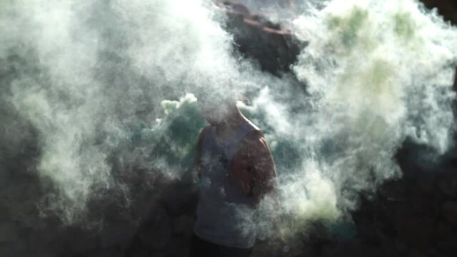 Slow Motion of Young Man Holding Smoke Bomb, Close Up