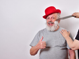 Man is getting a shave with a huge bowie knife...Self isolated man gets a shave with a large...