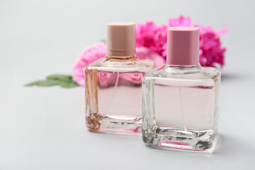 Bottles of floral perfume on grey background
