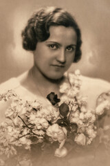 Latvia - CIRCA 1937: Wedding portrait of female with flowers in studio, Vintage Carte de Viste Art Deco era photo