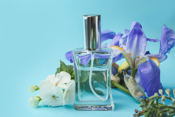 Bottle of floral perfume on color background