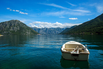 Old town settlement around lake, Kotor Bay, on background of blue sky and clouds, Montenegro, Europe