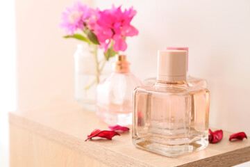 Obraz na płótnie Canvas Bottles of floral perfume on table