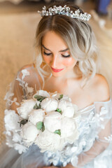 beautiful young woman in a tender blue dress with a bouquet