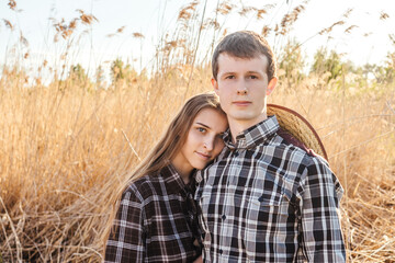 Loving couple in the field. Sunset.