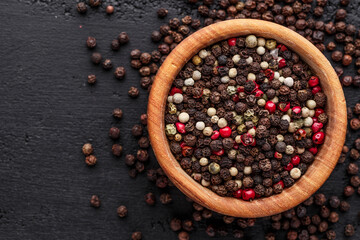 A set of peppers.Collage of different type pepper, Black ,white, pink and allspice peppercornsr,...