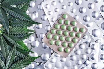Marijuana leaf and medical pills.Legalizing marijuana for medical purposes.Hemp buds - medical...